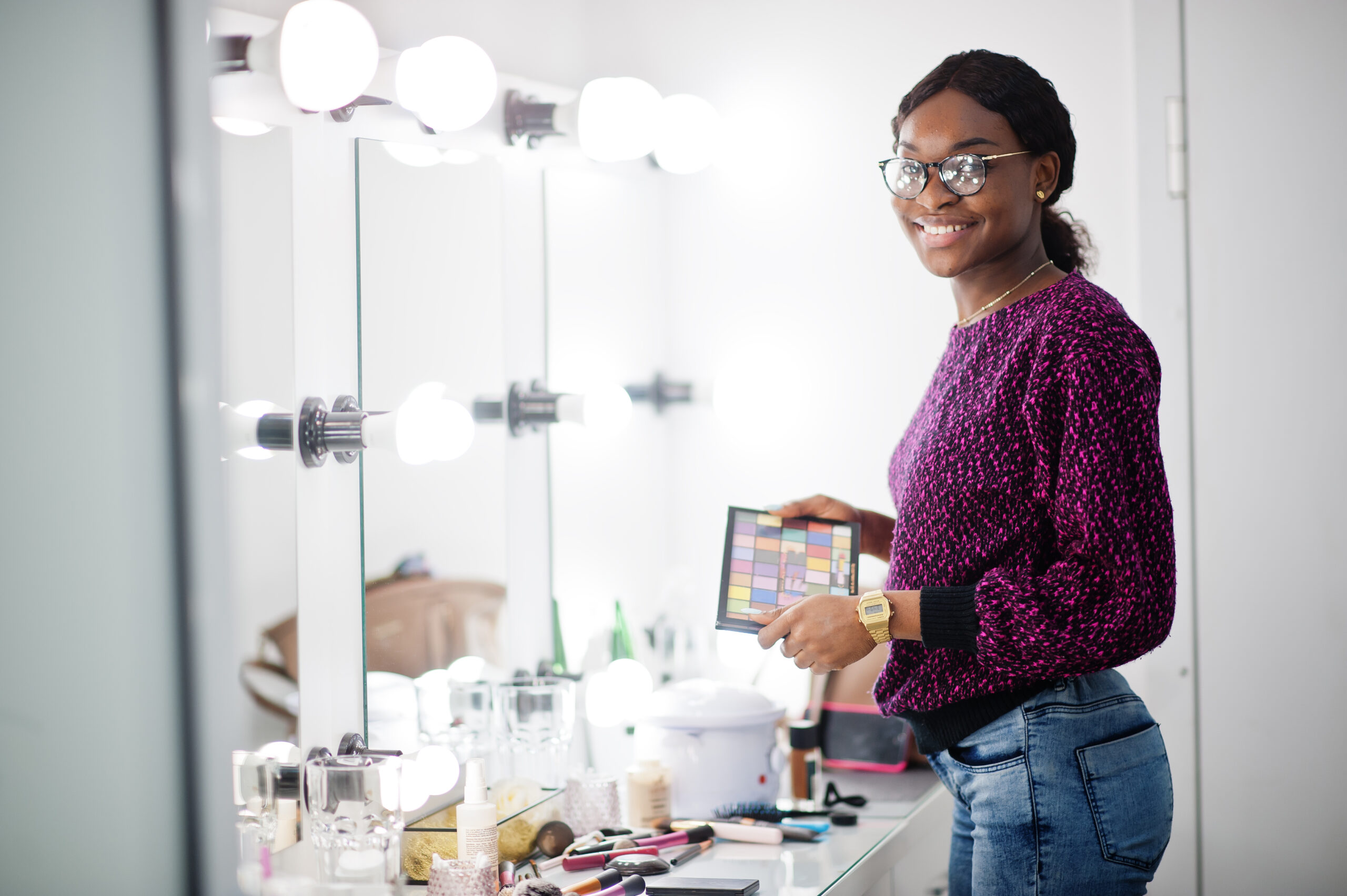 African American woman make-up artist at beauty saloon.